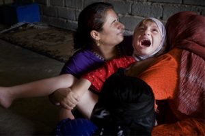A young Muslim girl screams as her clitoris is forcibly cut away.